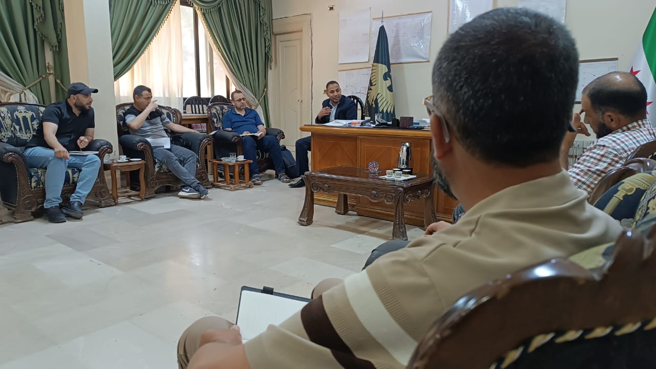 A coordination meeting between the Water Resources Directorate and the 'World Without Hunger' organisation in Hama to discuss rehabilitation projects.