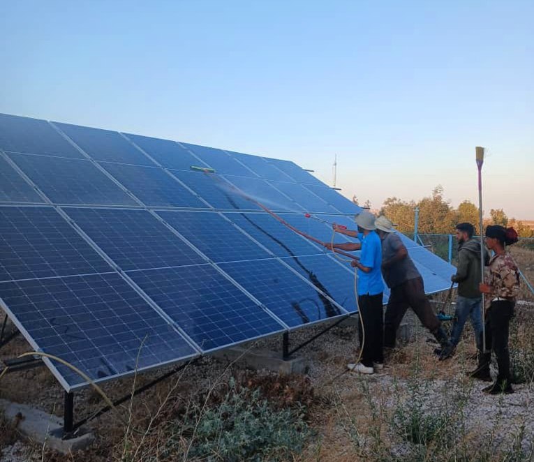 Washing the solar panels at the Brega pumping station to boost their efficiency and keep them running